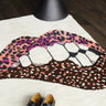 Rug with lip-shaped, leopard print design, with black shoes in front.