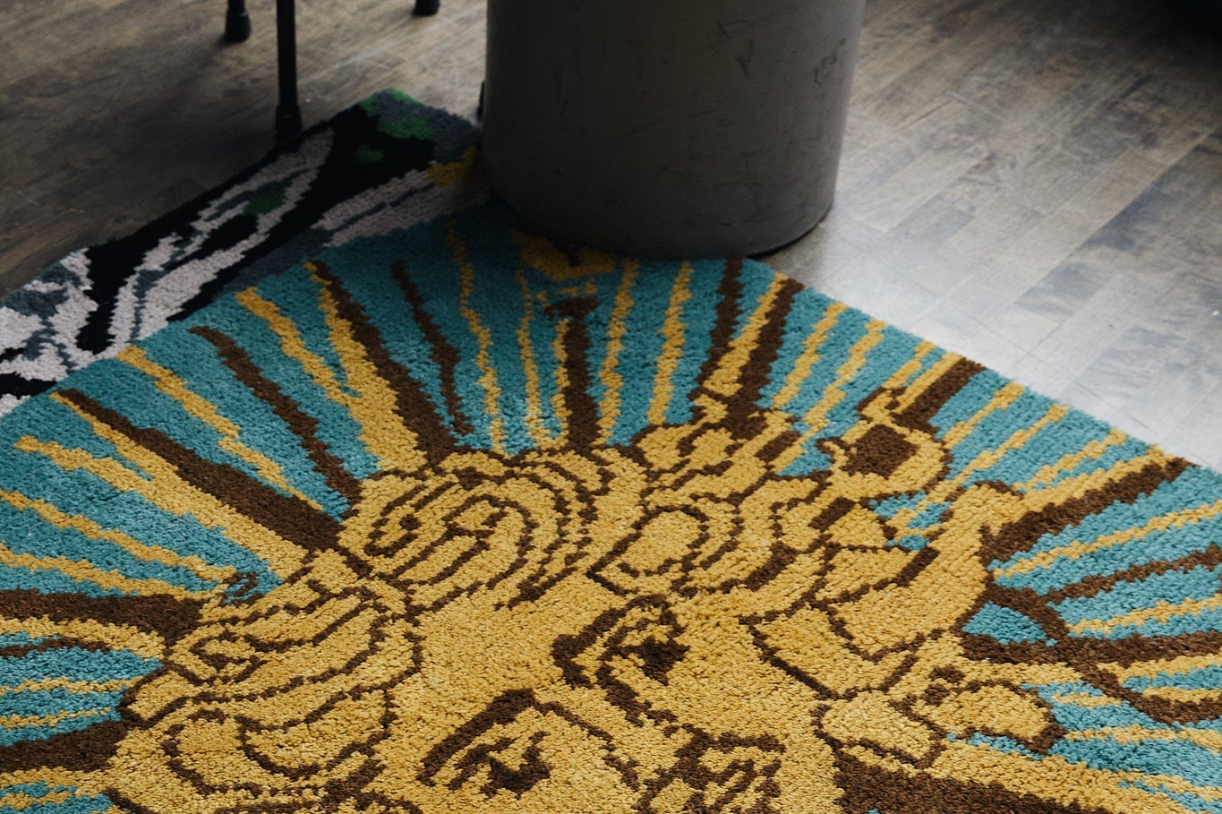 Area rug with large, sun design. Styled in a modern interior in Toronto, ON.