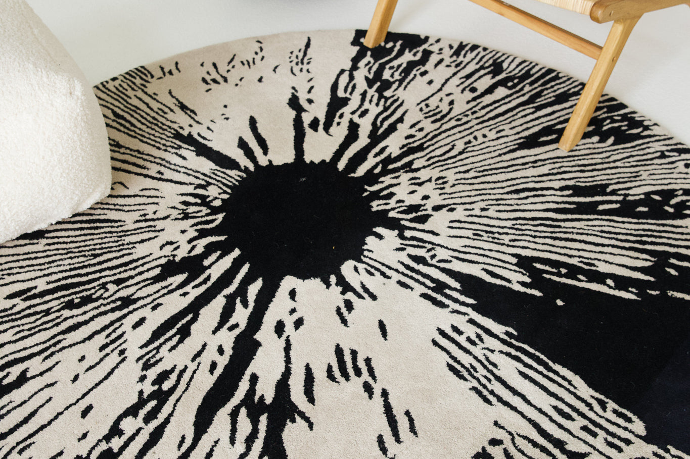 Round black and cream rug with bold abstract design. Created by Toronto carpet store, Studio321B